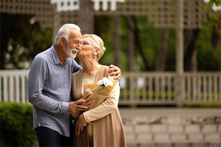 An old woman kisses her husband