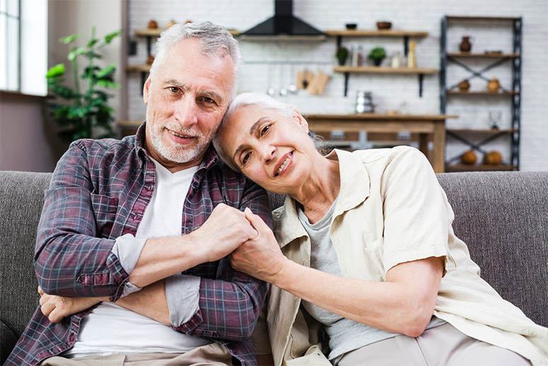 Old couple sitting on the couch