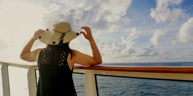 A woman standing on the deck of a cruise ship