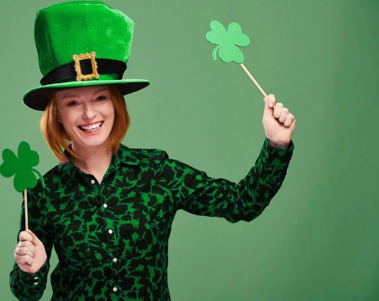 Woman with a hat, holding clover sticks