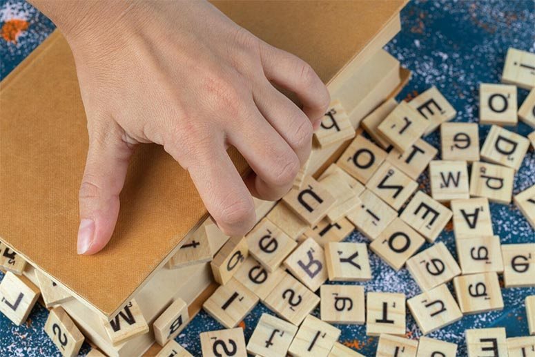 Hands opening a box full of wood cubes