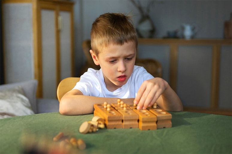 A boy playing with wooden toys