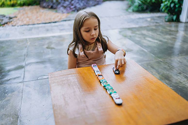 A girl play with car toys