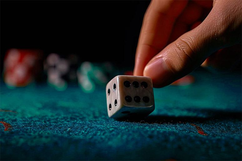 Hand and white dice