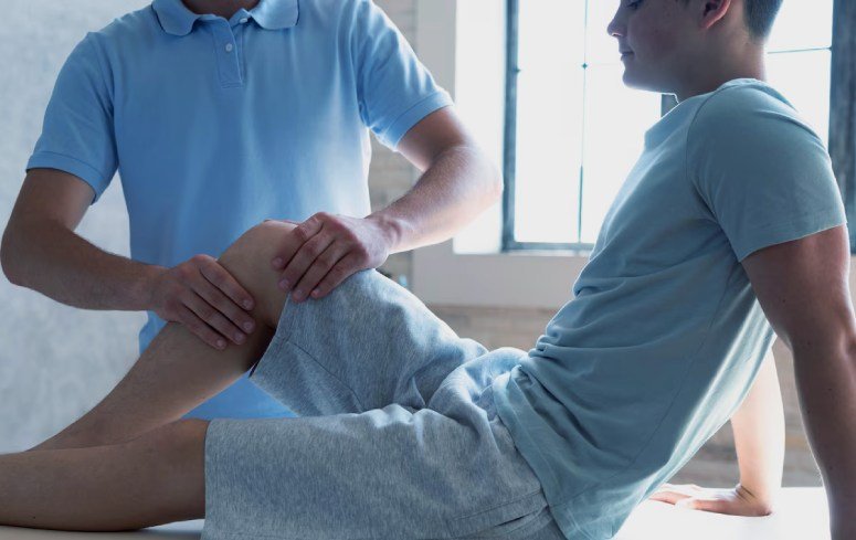 Chiropractor touching a boy's leg