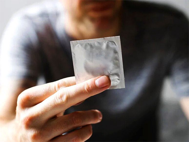 Man showing a condom