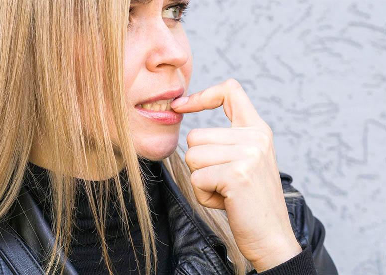 Blonde woman touches her lips 