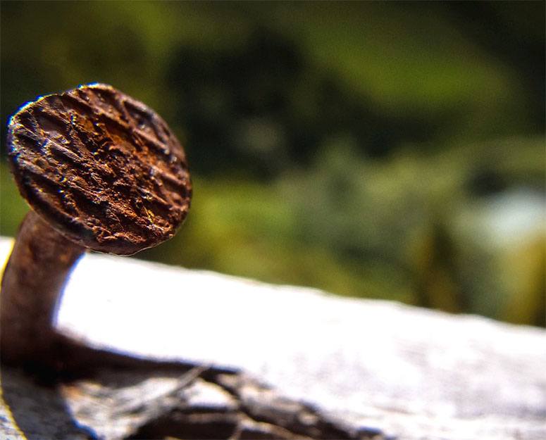 Close up of a crooked rusty nail