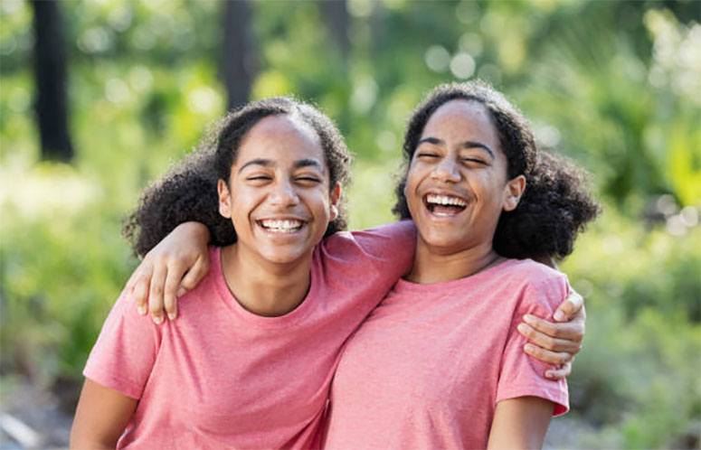 Twin girls dressed in pink