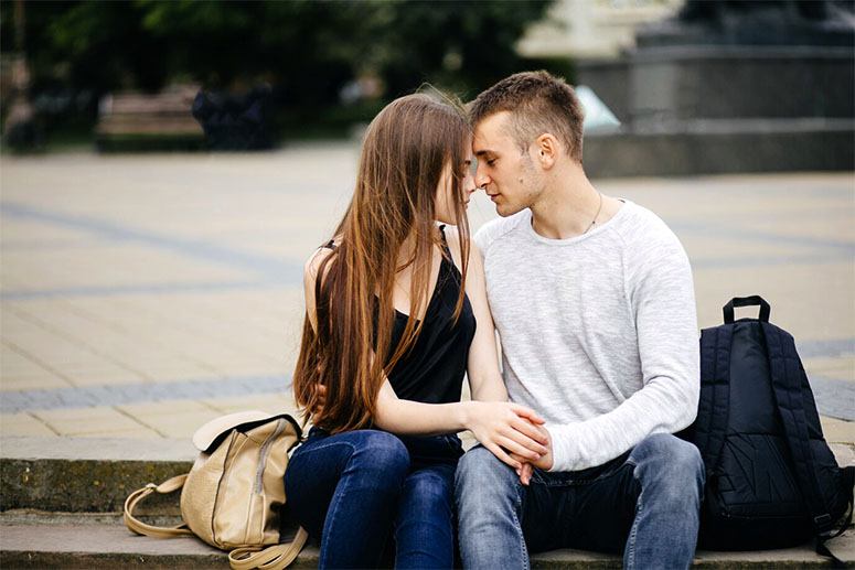 A couple is sitting and admiring each other