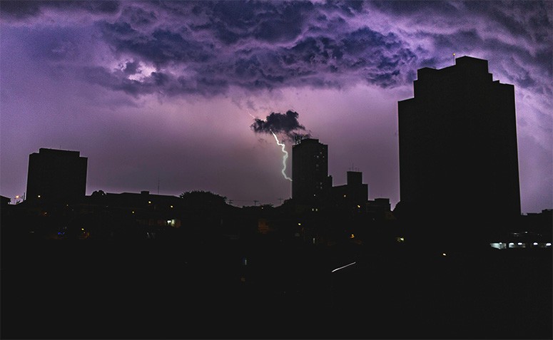 A city with a lightning storm into it