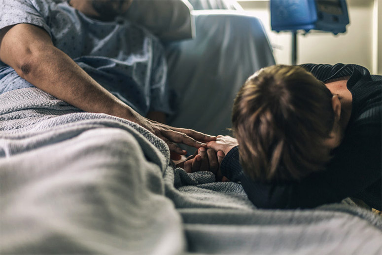 A man and a woman in a hospital bed